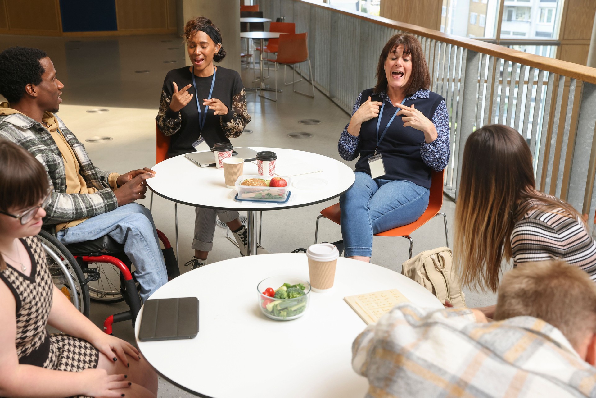 Disabled people talking at tables