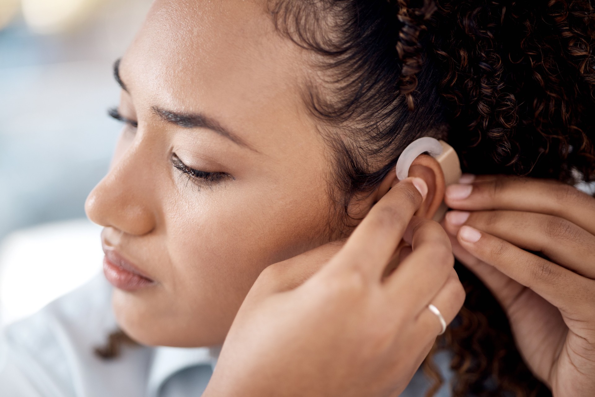 Deaf, hearing aid and disabled woman with disability, connect healthcare tech and health insurance. Medical, listening device or ear piece, young professional face with focus, help and communication