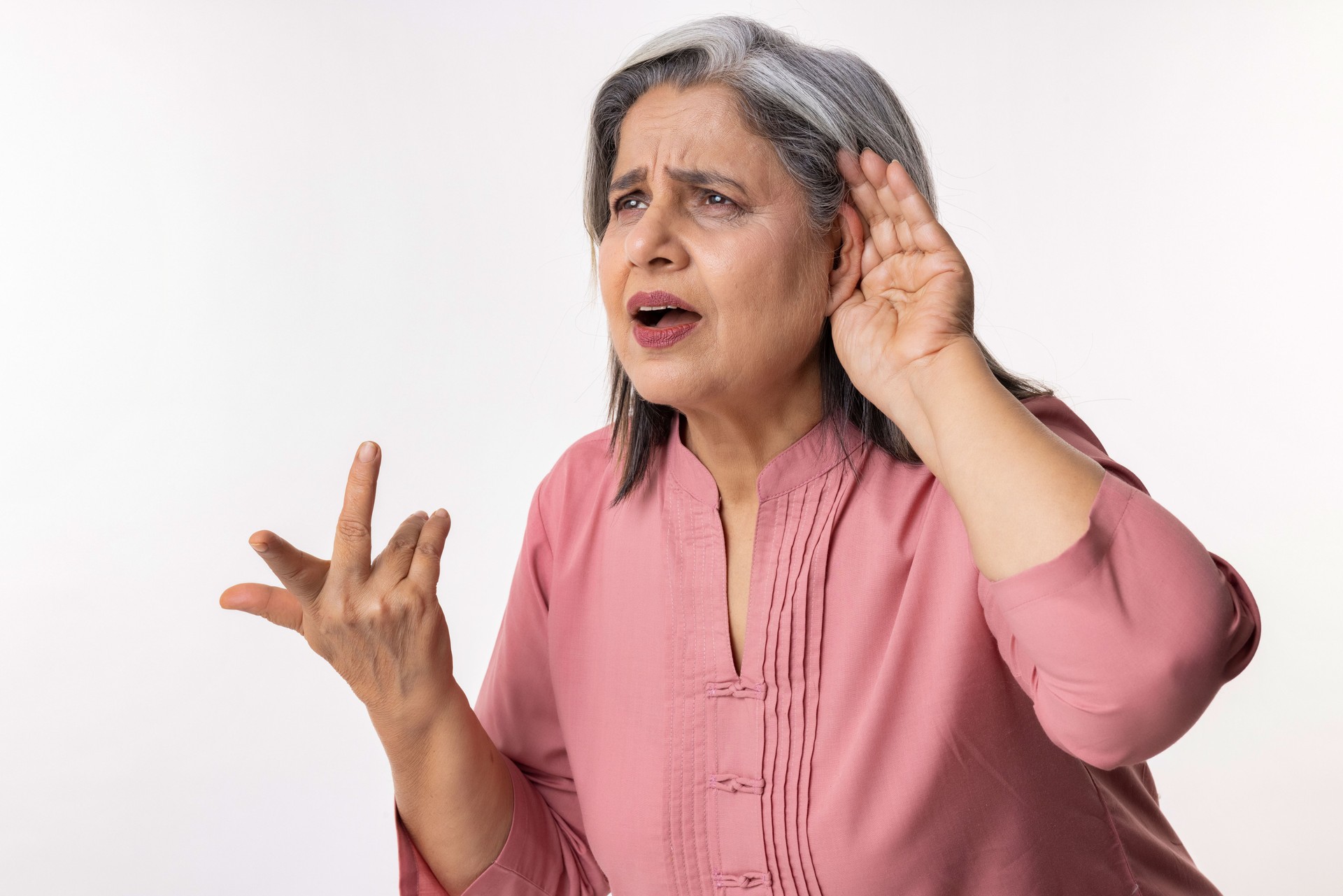Senior female cupping hand to her ear